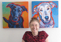 artist with two 20x20 custom dog paintings